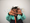 Blurred-out child holding their hands up in front of their face.